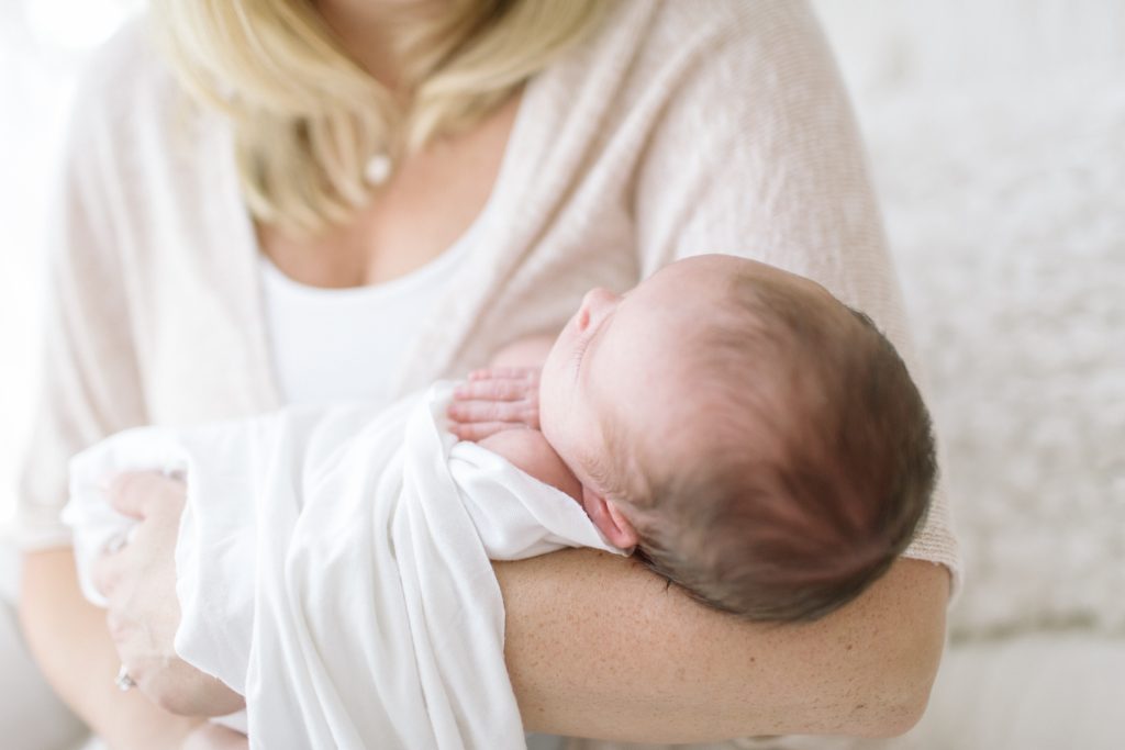 all white studio katie ballantine photography frederick maryland organic newborn photography mother holding swaddled baby
