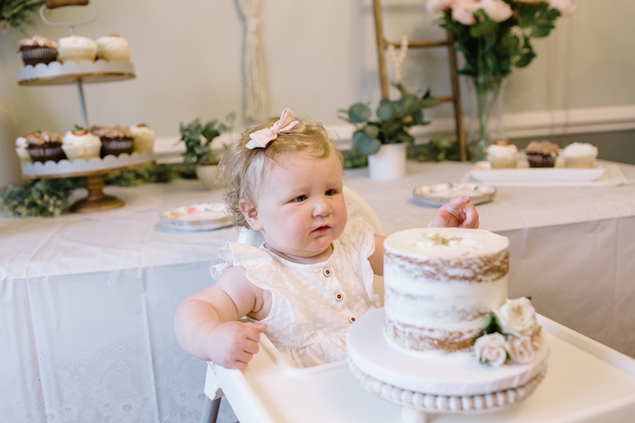 Frederick Maryland Baby Photographer. New Market photographer. Katie Ballantine Photography.  In home cake smash.  One year old eating cake