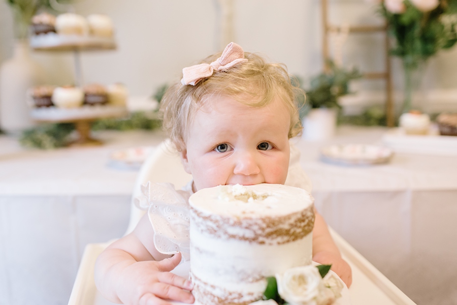 Frederick Maryland Baby Photographer. New Market photographer. Katie Ballantine Photography.  In home cake smash.  One year old eating cake