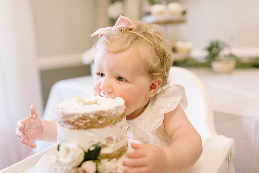 Frederick Maryland Baby Photographer. New Market photographer. Katie Ballantine Photography.  In home cake smash.  One year old eating cake