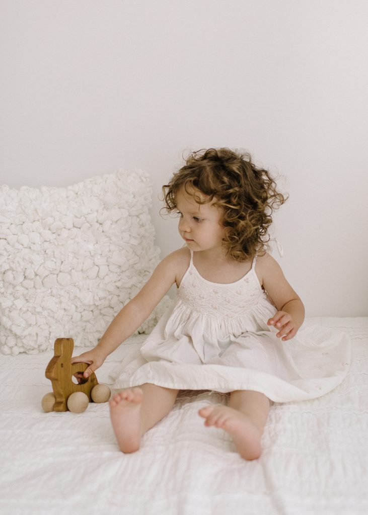 Katie Ballantine Photography. New Market, Frederick Maryland Baby and Child Photographer.  All white studio mini session.  Organic photography.  Children on white bed.