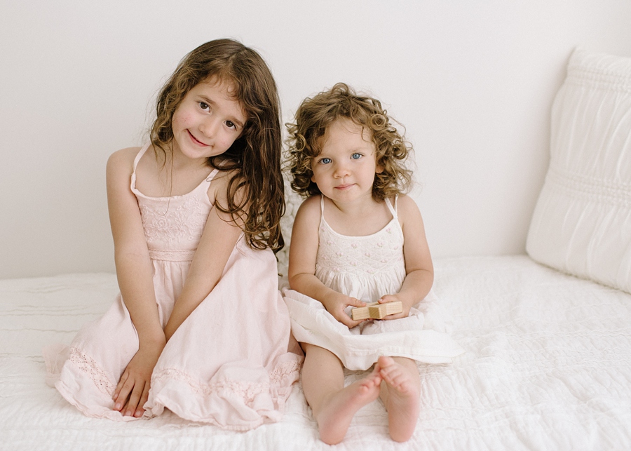 Katie Ballantine Photography. New Market, Frederick Maryland Baby and Child Photographer.  All white studio mini session.  Organic photography.  Children on white bed.