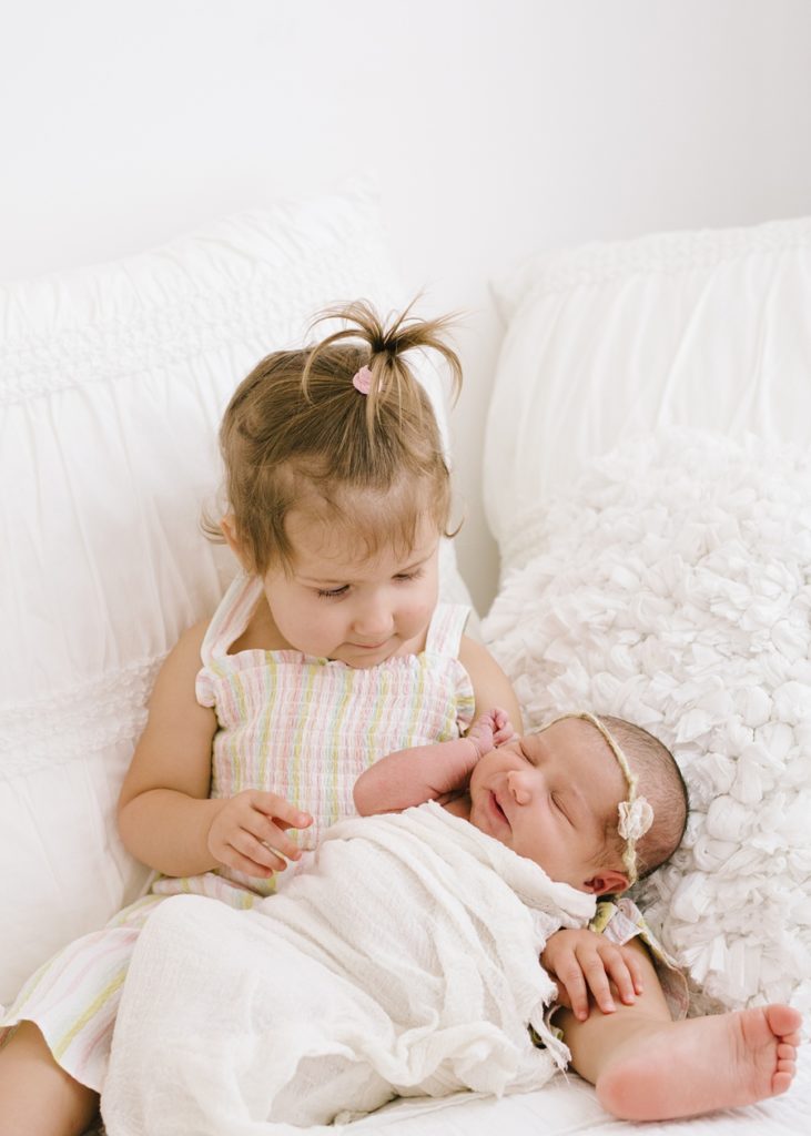 Katie Ballantine Photography. Frederick and Newborn Photographer.  All white studio.  Toddler and newborn image