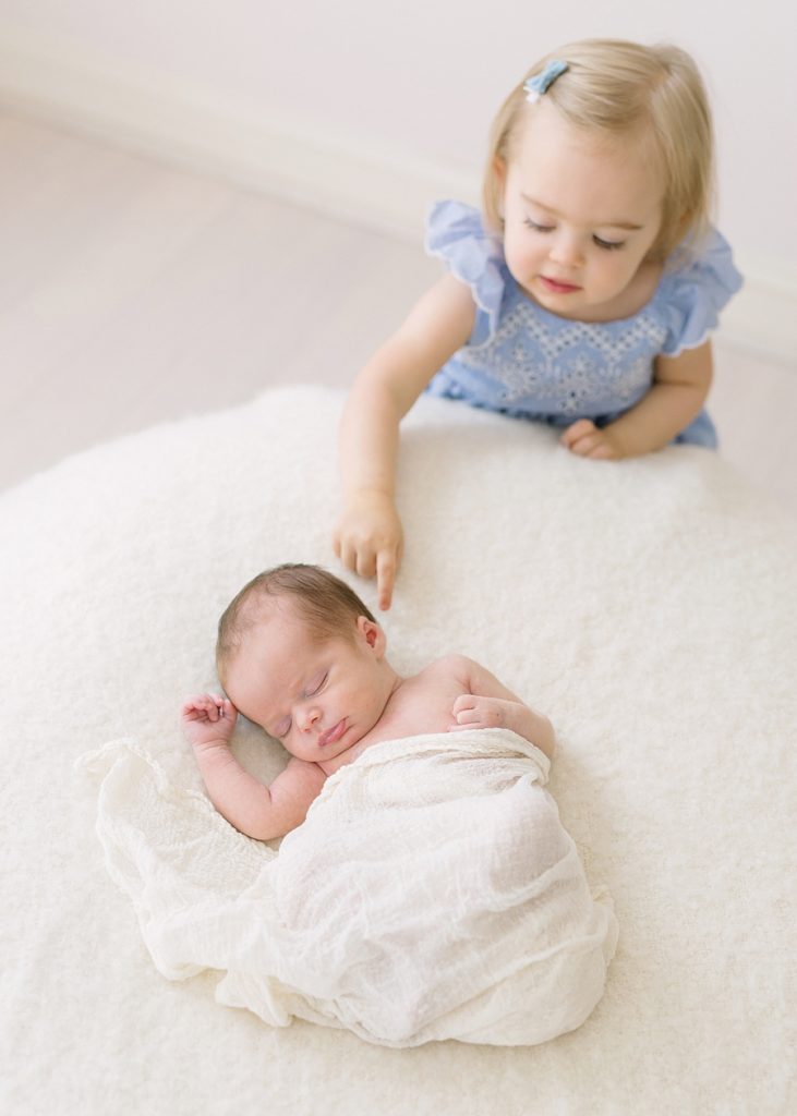 Katie Ballantine Photography. Frederick and Newborn Photographer.  All white studio.  Toddler and newborn with family