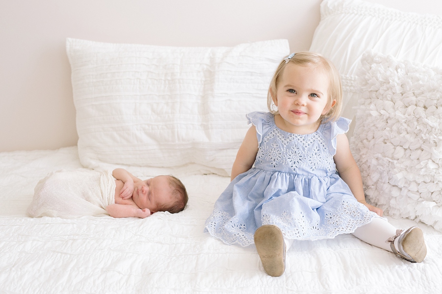 Katie Ballantine Photography. Frederick and Newborn Photographer.  All white studio.  Toddler and newborn with family
