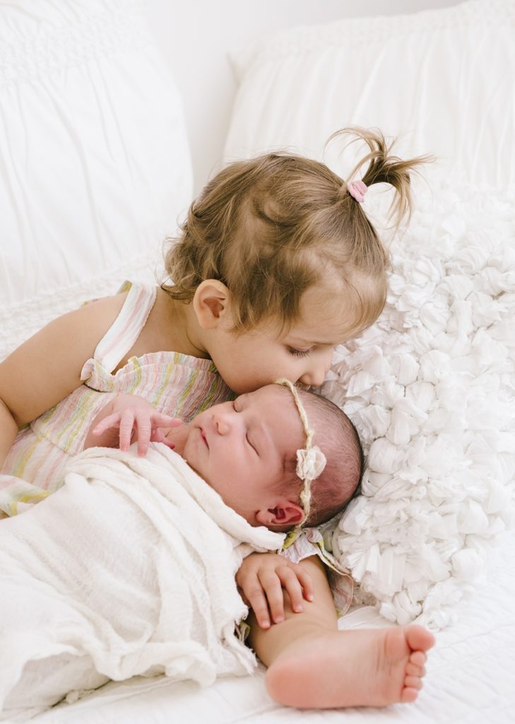 Katie Ballantine Photography, Frederick Maryland Newborn Photographer, sibling and newborn image, toddler holding baby, all white studio, organic newborn portraiture