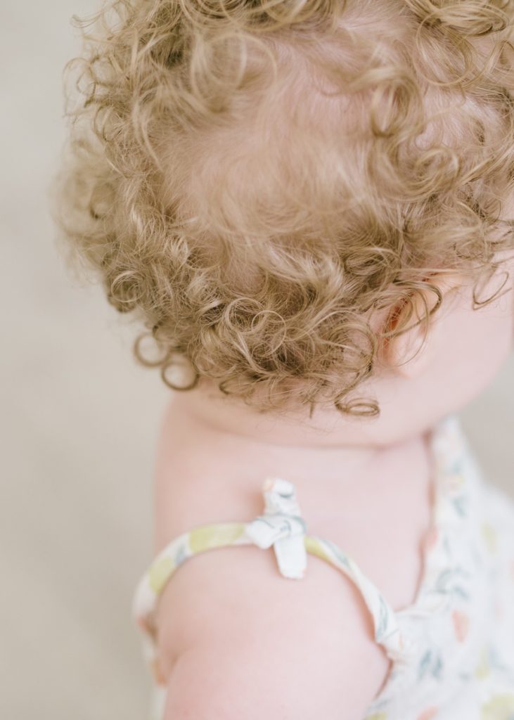 katie ballantine photography. frederick baby photographer.  baby in natural light studio. milestone session. baby curls