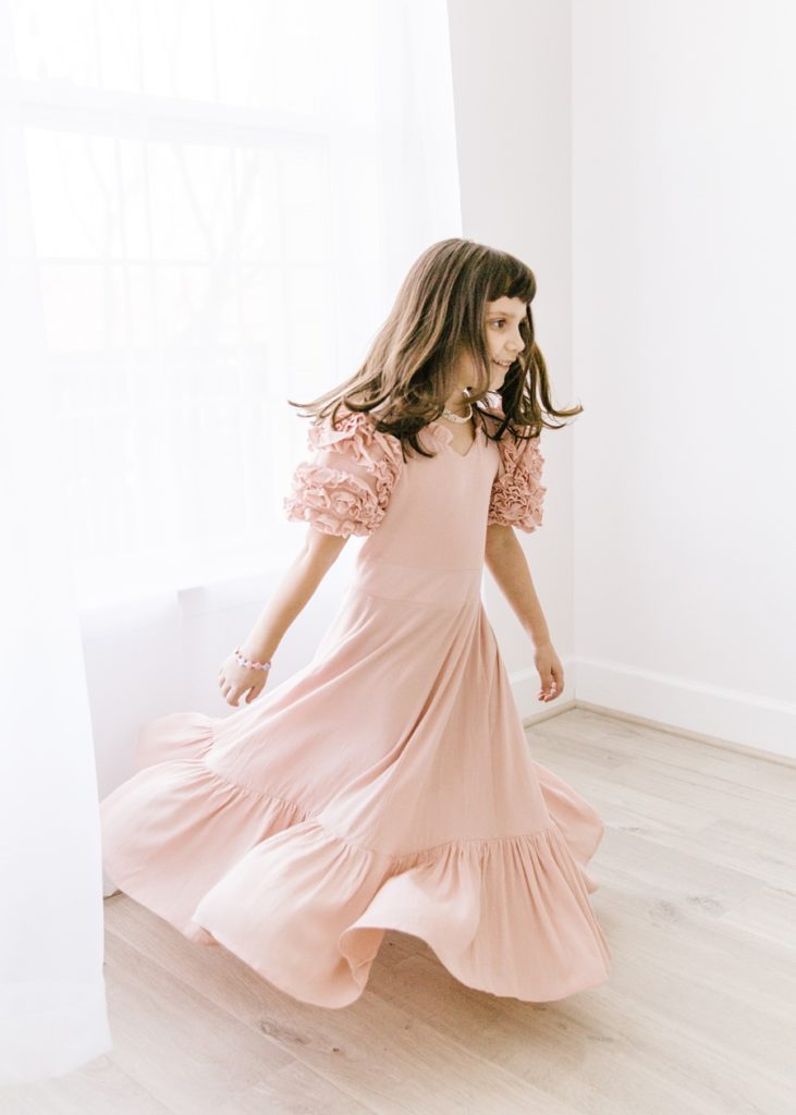 Katie Ballantine Photography.  Frederick Maryland Child Photographer.  New Market, Maryland Studio Child Photographer.  Girl in pink dress twirling